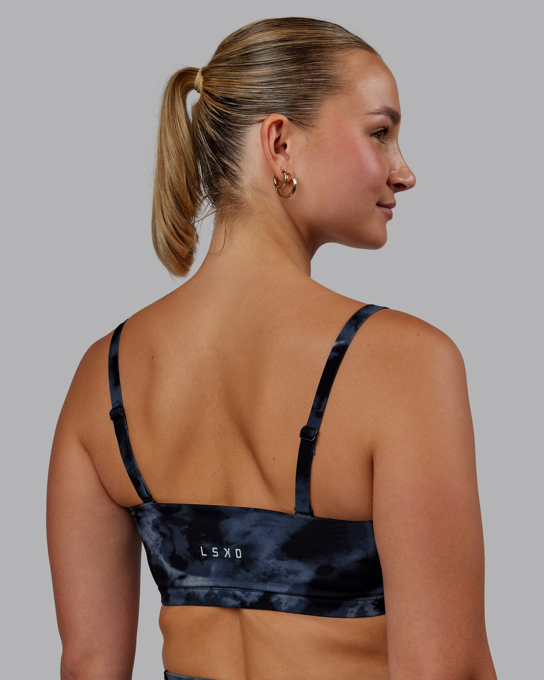 Woman wearing Inspire Sports Bra - Tie Dye-Midnight