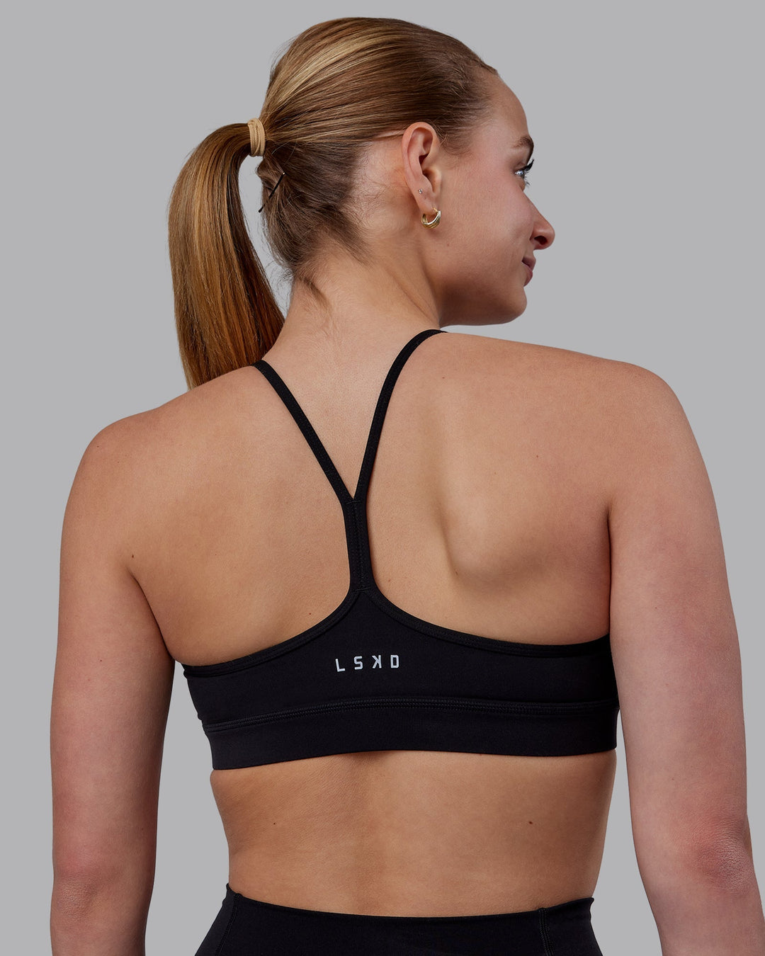 Woman wearing Lift High Neck Sports Bra - Black