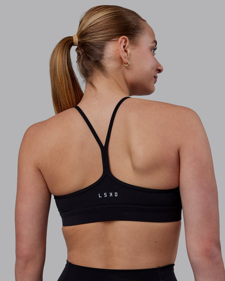 Woman wearing Lift High Neck Sports Bra - Black
