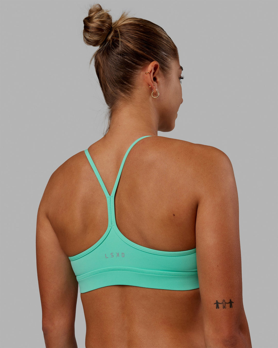 Woman wearing Lift High Neck Sports Bra - Cockatoo