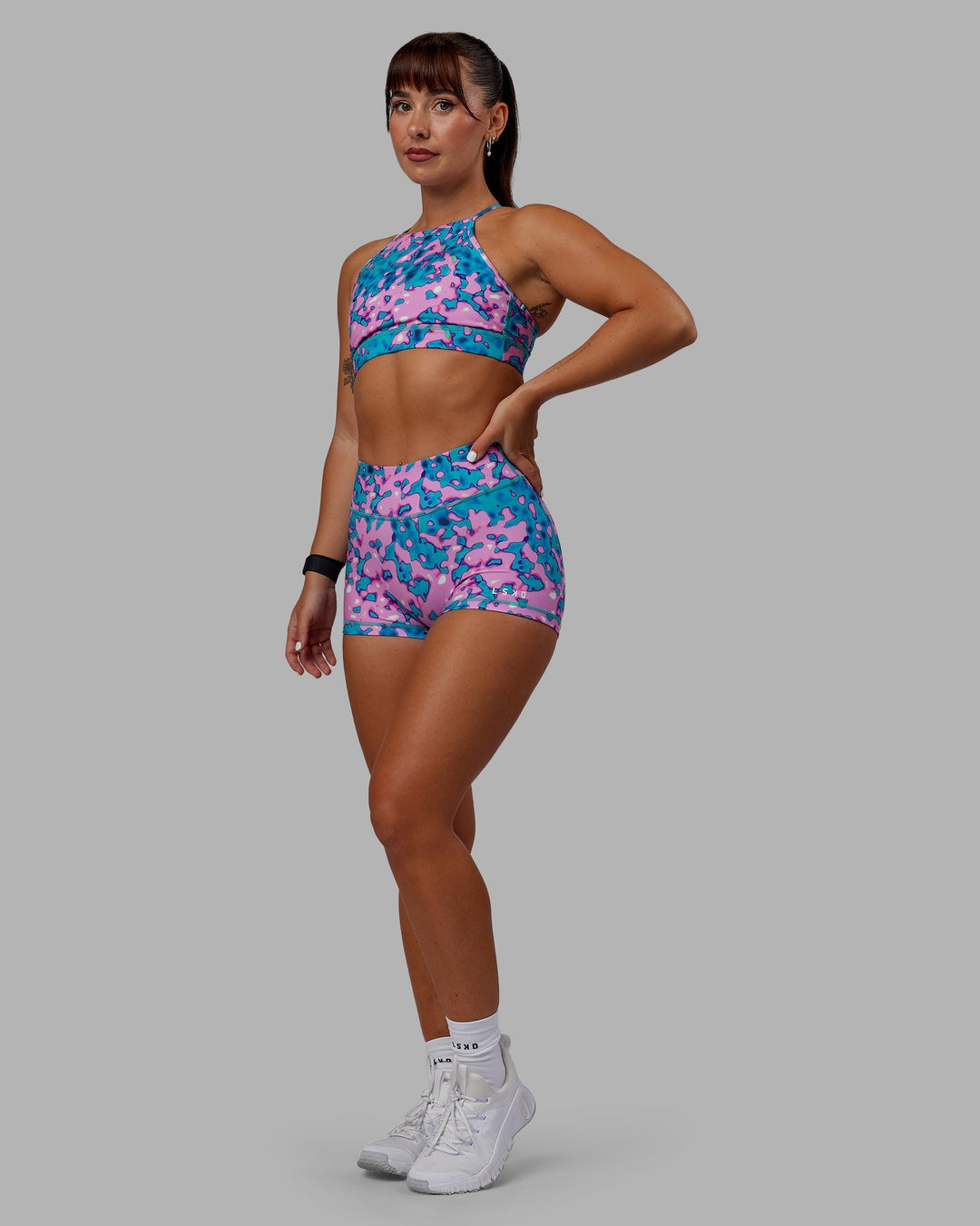 Woman wearing Lift High Neck Sports Bra - Neon Camo