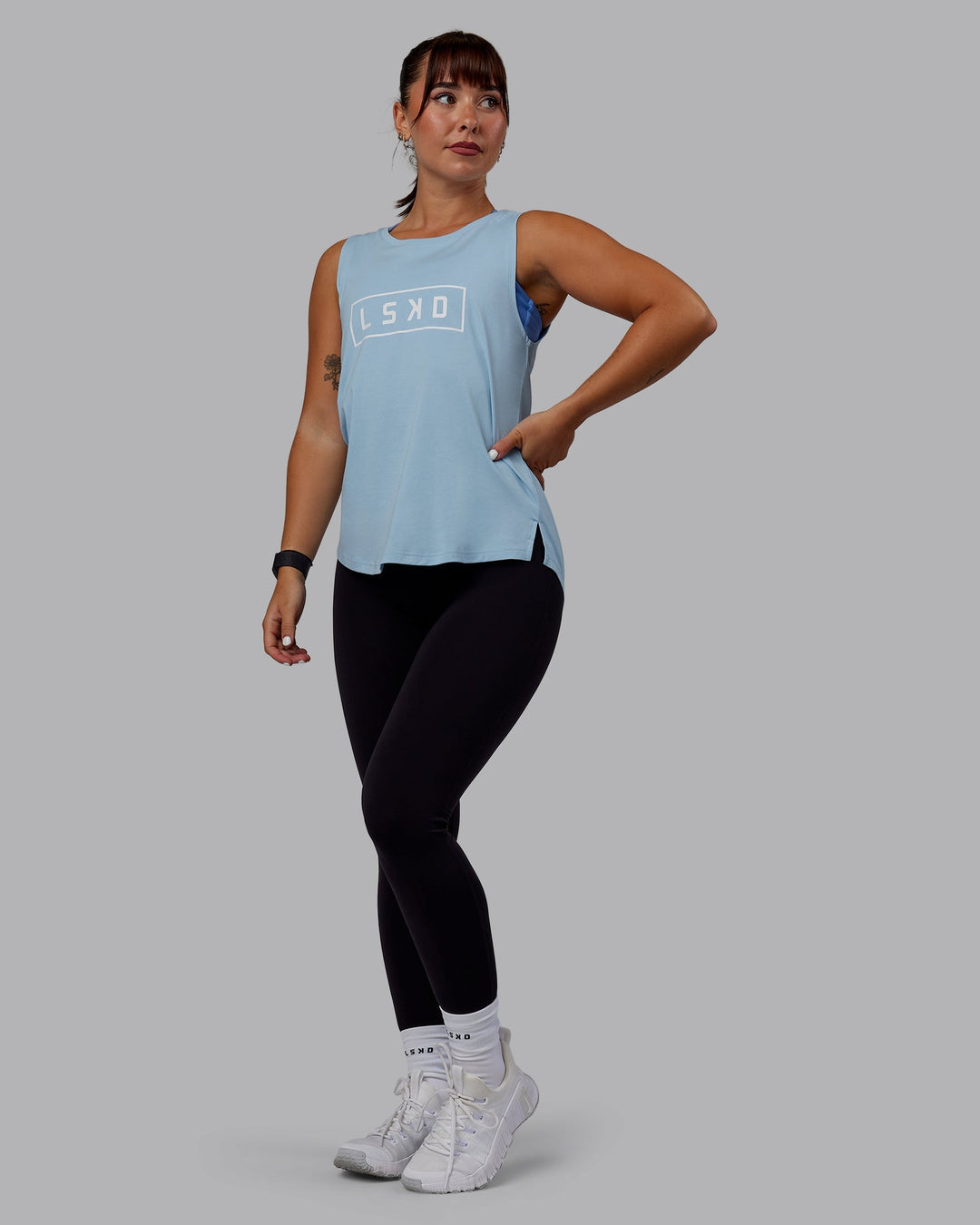 Woman wearing Luna FLXCotton Longline Tank - Glacial Blue-White