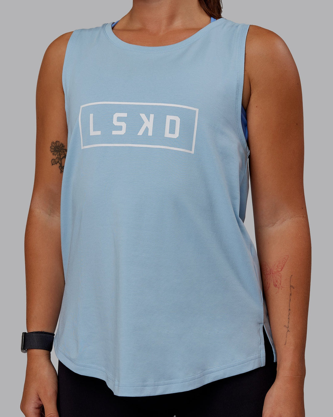 Woman wearing Luna FLXCotton Longline Tank - Glacial Blue-White