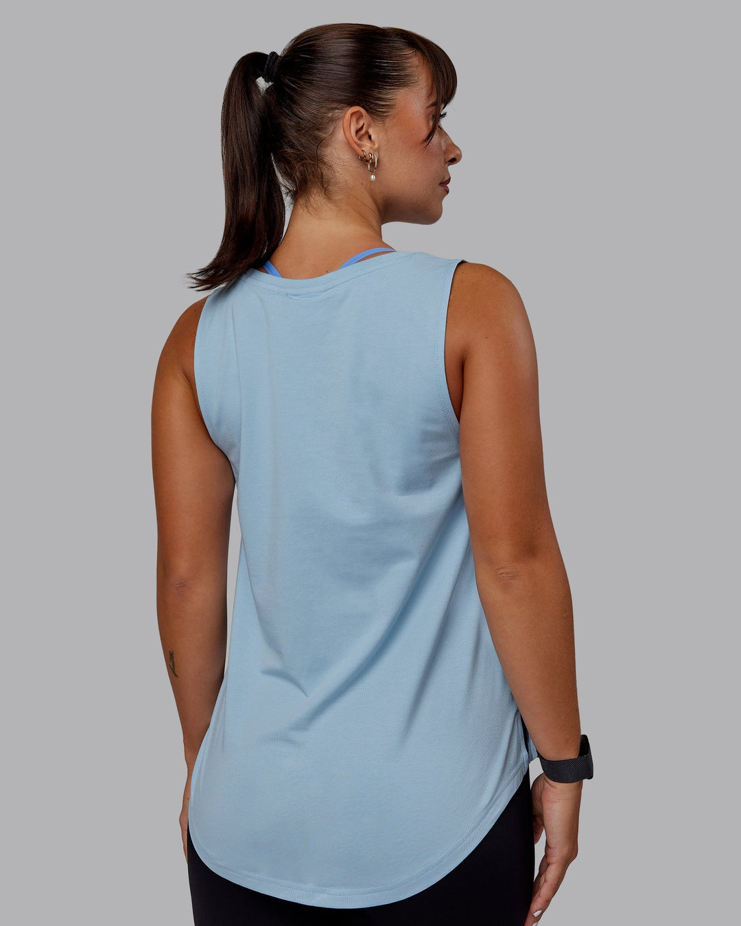 Woman wearing Luna FLXCotton Longline Tank - Glacial Blue-White