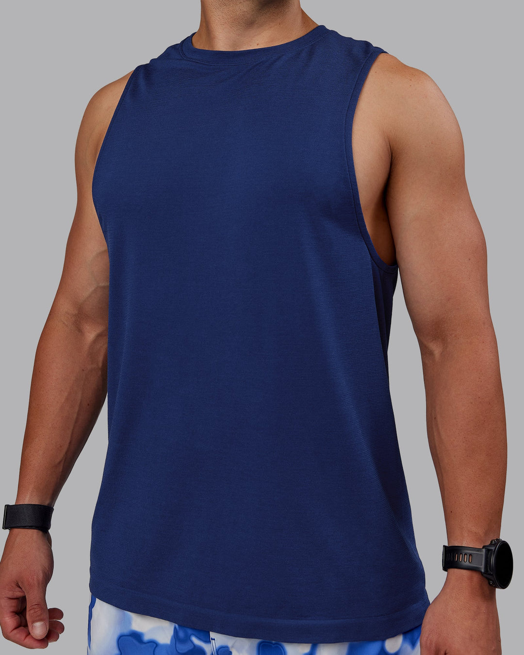 Man wearing AeroFLX+ Seamless Muscle Tank - Midnight Blue/Midnight Blue Marl