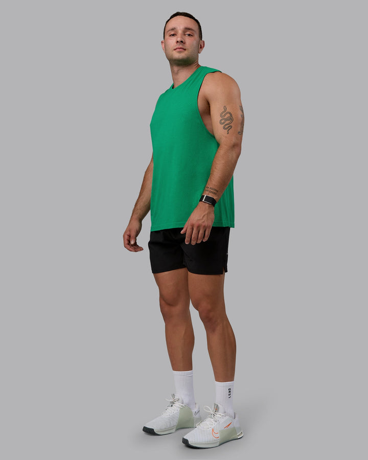 Man wearing AeroFLX+ Seamless Muscle Tank - Pepper Green/Impact Green
