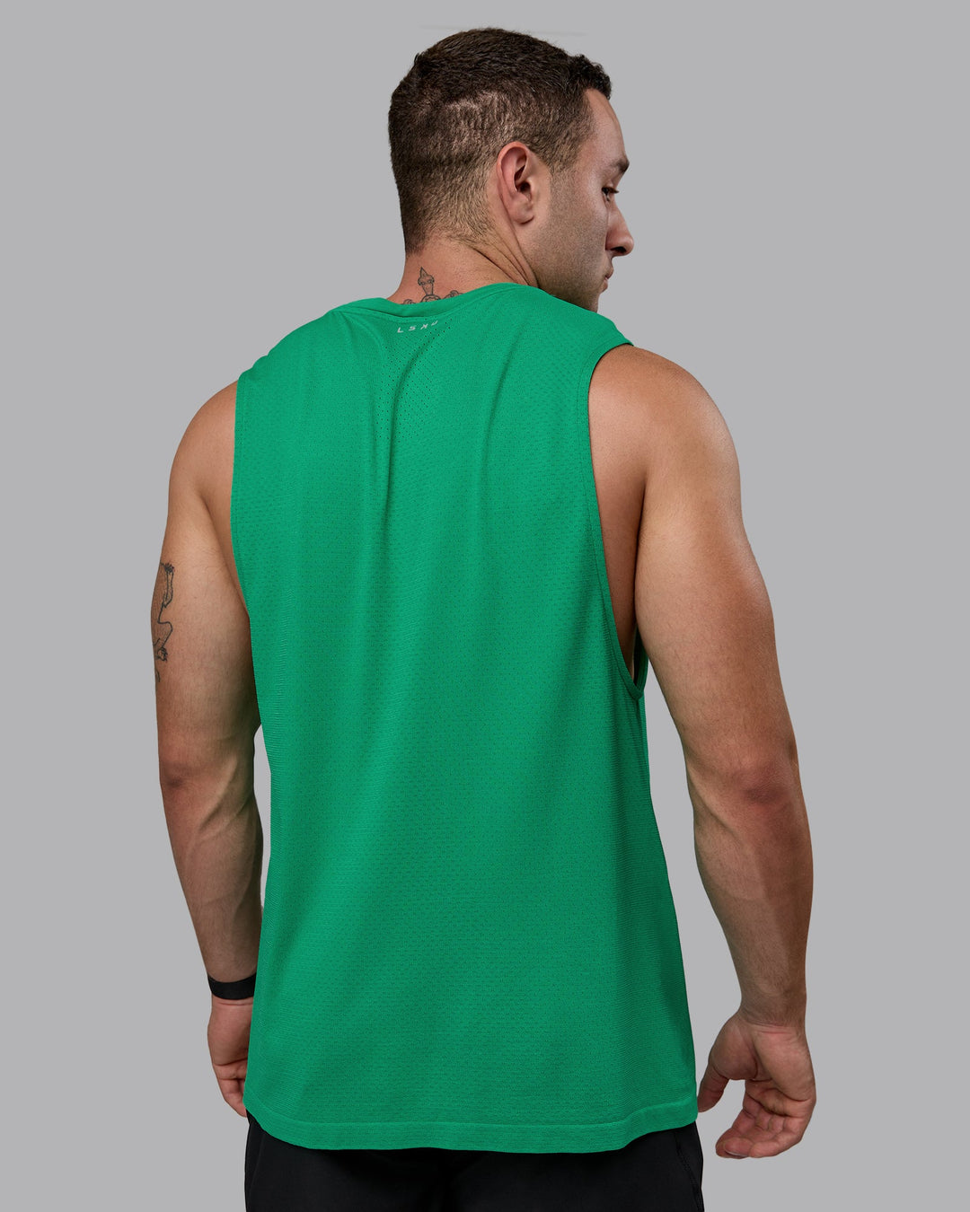 Man wearing AeroFLX+ Seamless Muscle Tank - Pepper Green/Impact Green