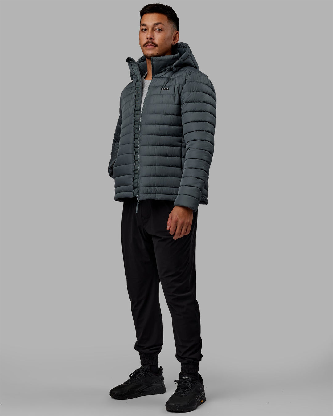 Man wearing All Day Puffer Jacket - Storm