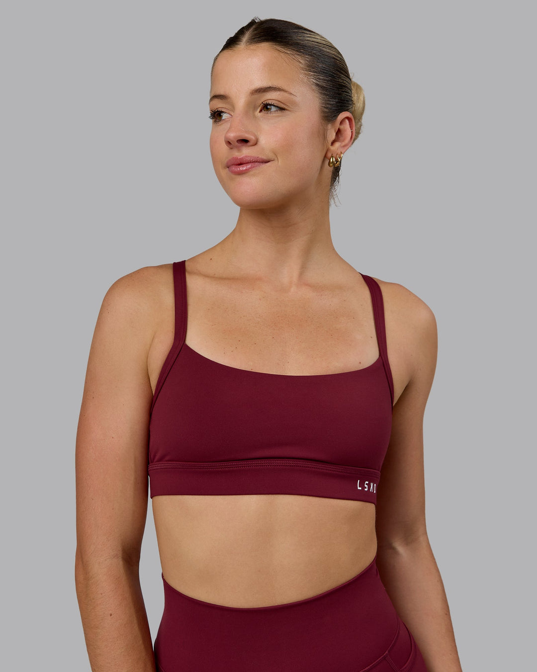 Woman wearing Momentum Sports Bra - Cordovan