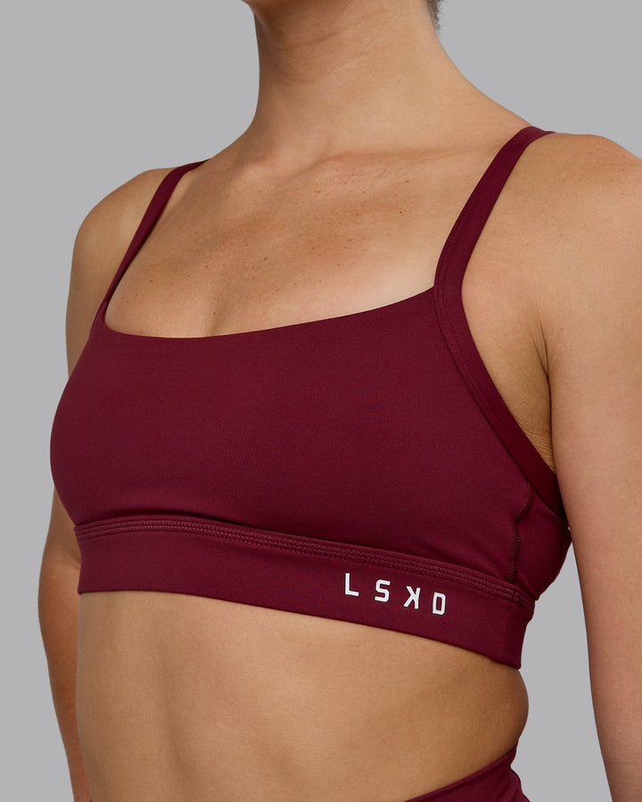 Woman wearing Momentum Sports Bra - Cordovan
