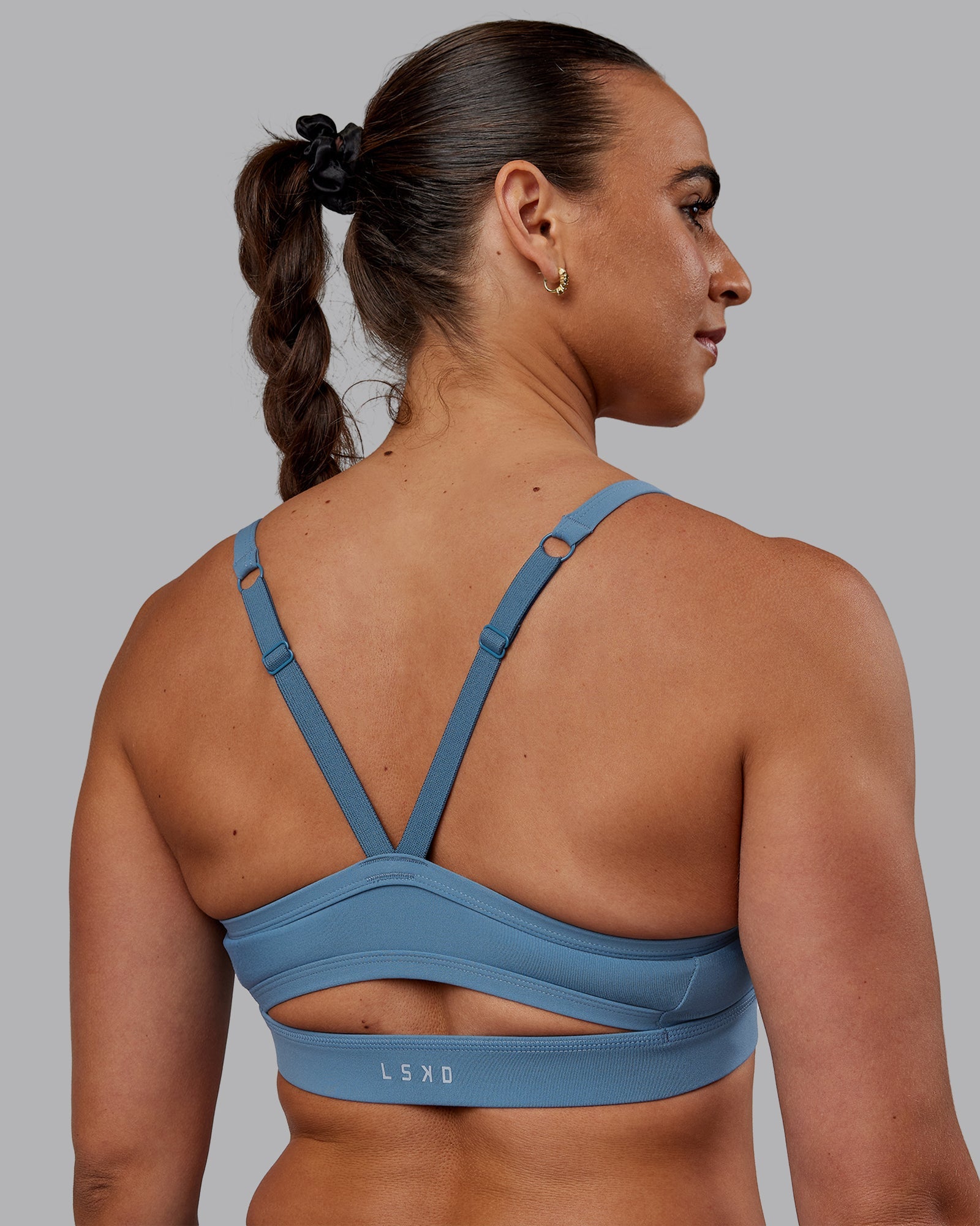 Woman wearing Momentum Sports Bra - Elemental Blue