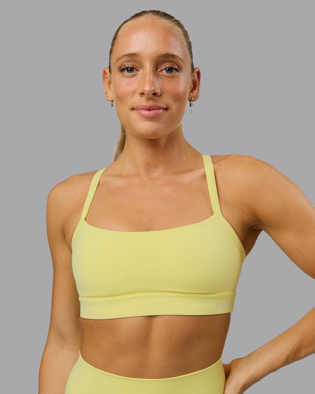 Woman wearing Momentum Sports Bra - Lemon Fizz