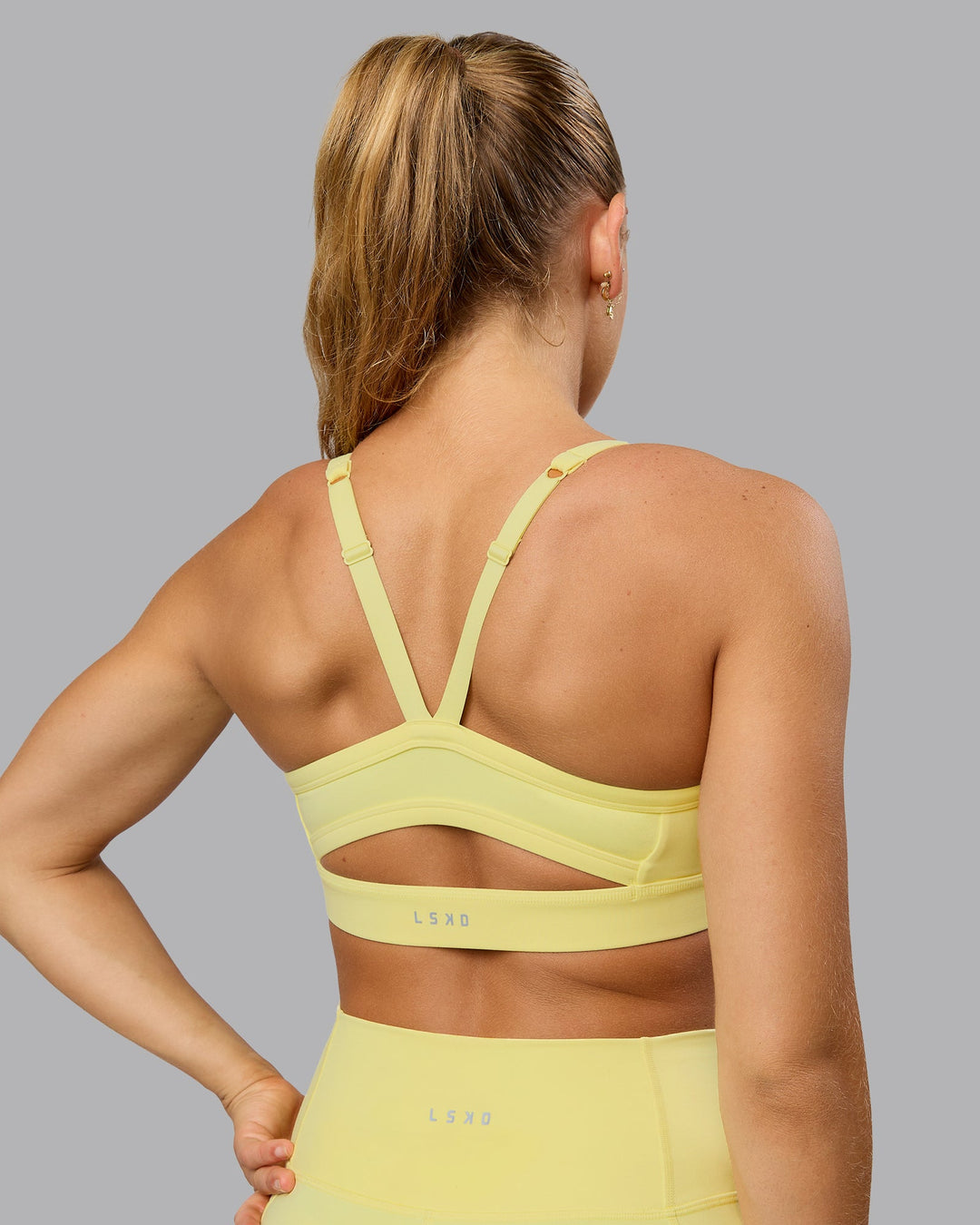 Woman wearing Momentum Sports Bra - Lemon Fizz