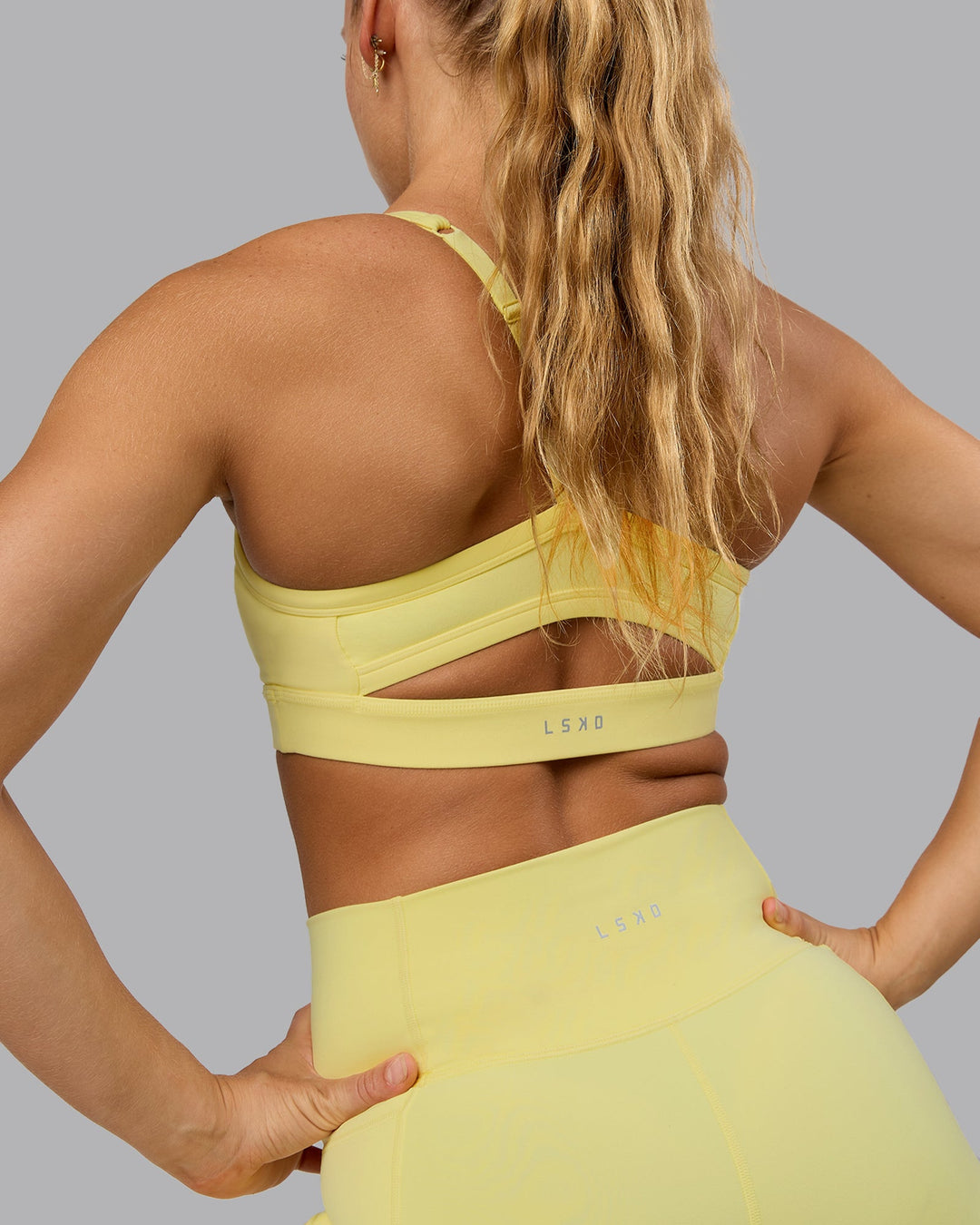 Woman wearing Momentum Sports Bra - Lemon Fizz