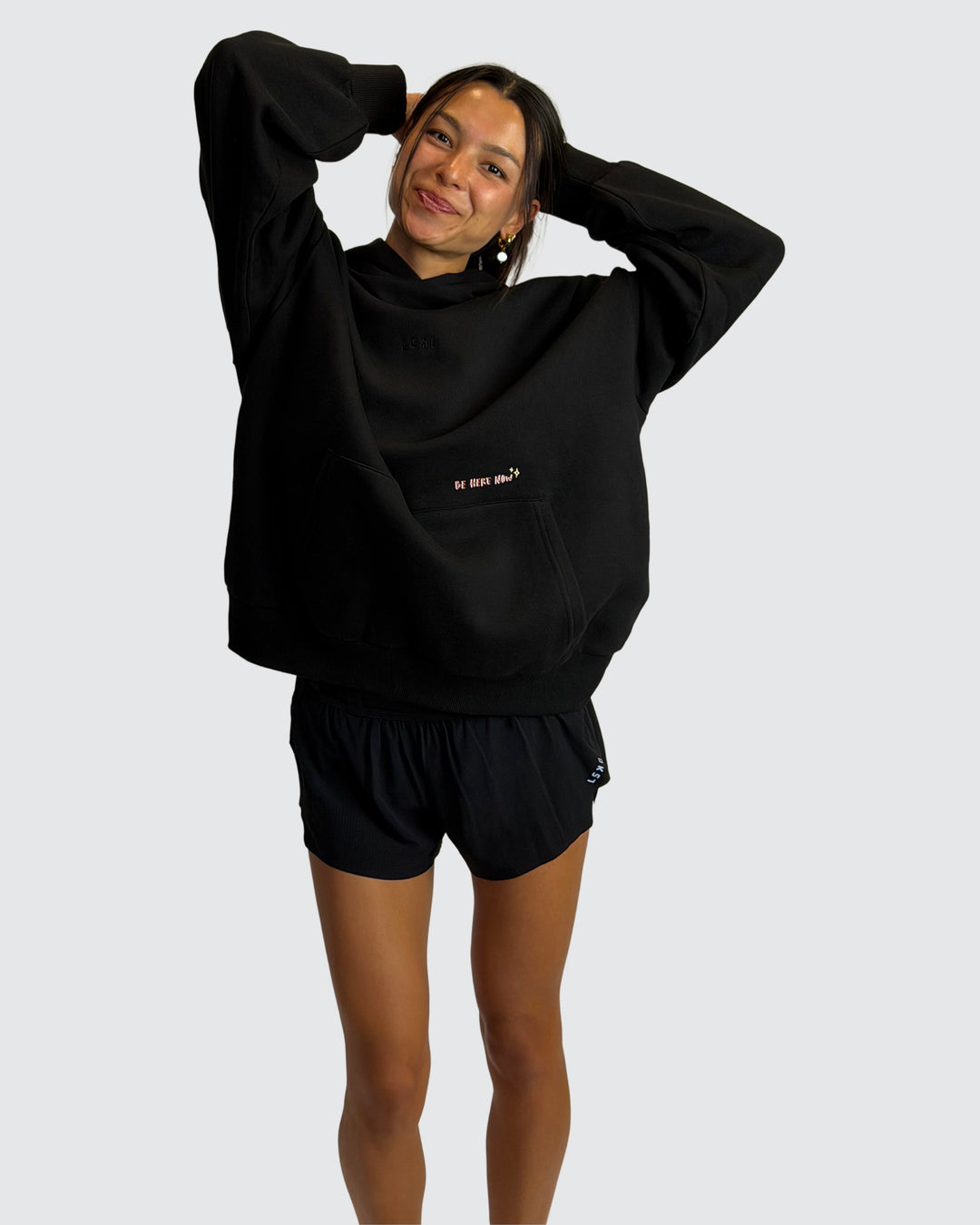 Woman wearing Oversized Apres Run Club MVP Hoodie - Black | Model:Meg | Size:XS