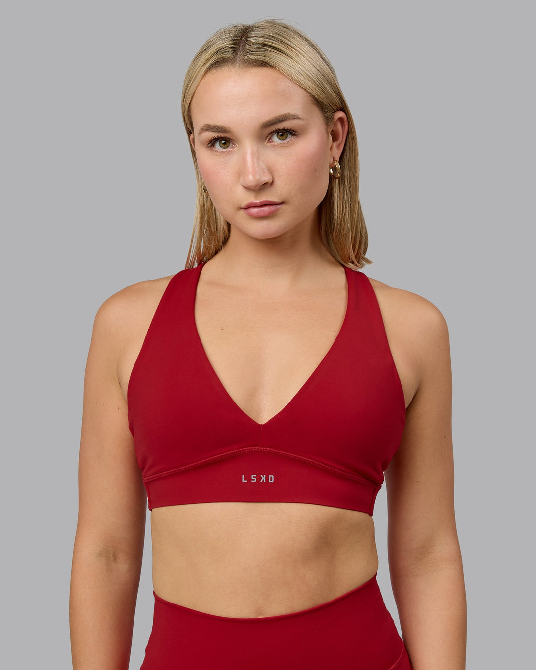 Woman wearing Poise Sports Bra - Cherry Red