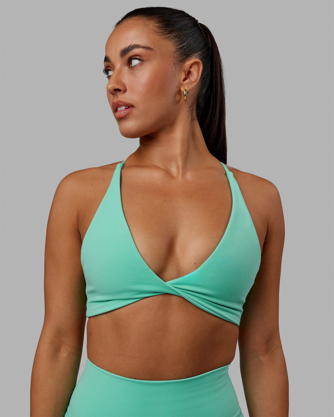 Woman wearing Progression Sports Bra - Aquatic Awe