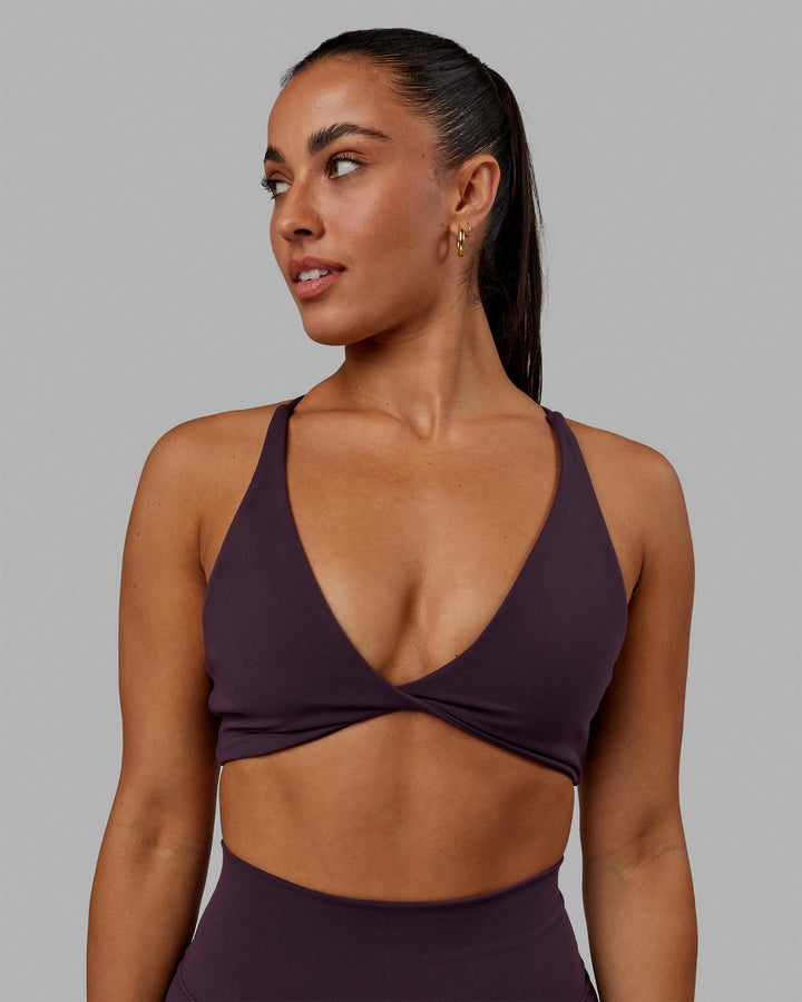 Woman wearing Progression Sports Bra - Midnight Plum