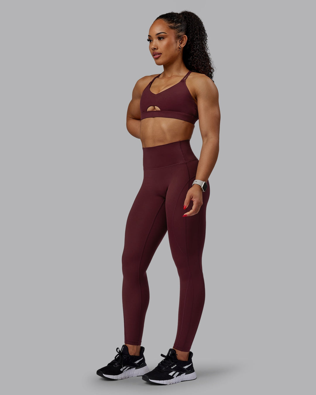 Woman wearing Pursue Sports Bra - Dark Cherry