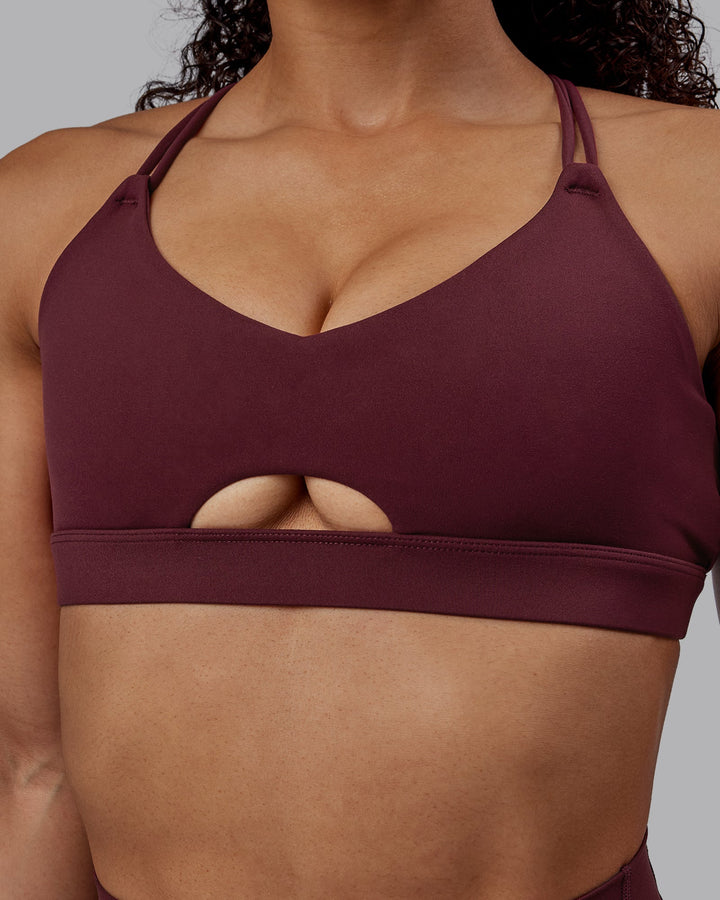 Woman wearing Pursue Sports Bra - Dark Cherry
