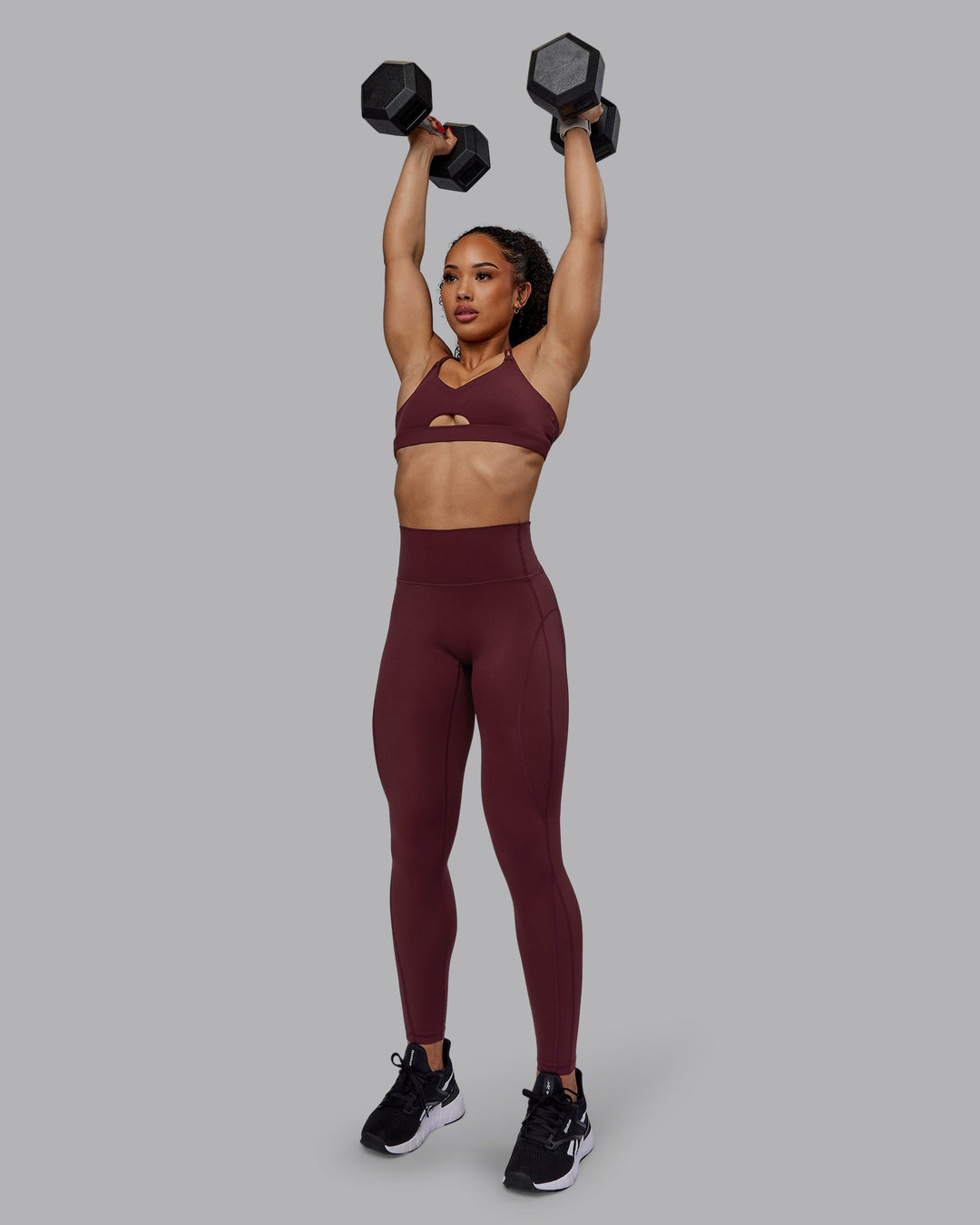 Woman wearing Pursue Sports Bra - Dark Cherry