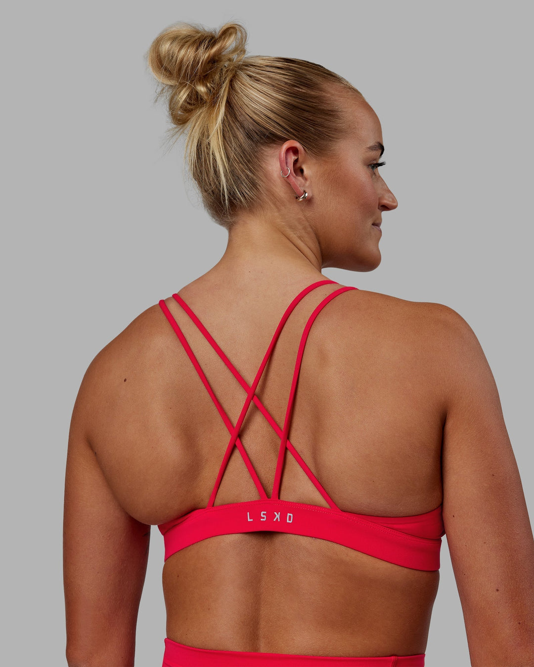 Woman wearing Pursue Sports Bra - Scarlet