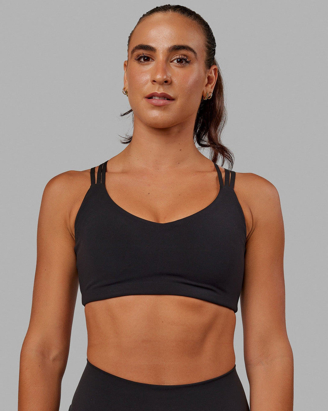 Woman wearing Push The Limit Sports Bra - Black