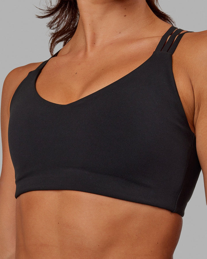 Woman wearing Push The Limit Sports Bra - Black
