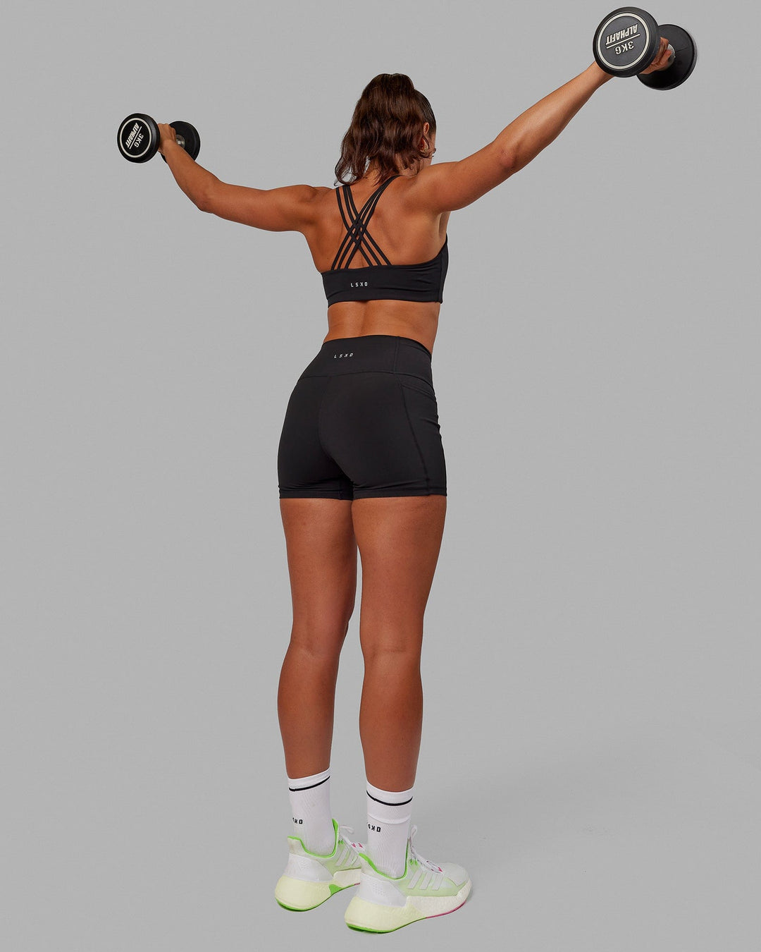 Woman wearing Push The Limit Sports Bra - Black