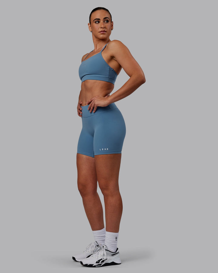 Woman wearing RXD Mid-Length Shorts - Elemental Blue
