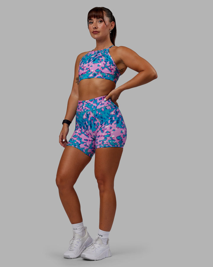 Woman wearing RXD Mid-Length Shorts - Neon Camo
