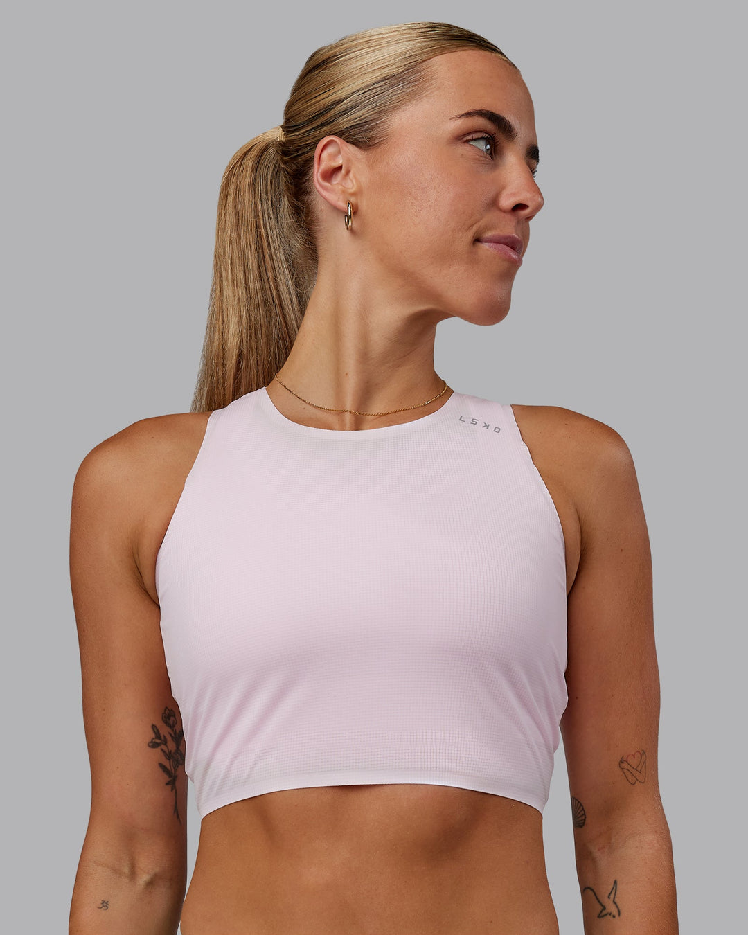 Woman wearing Race Day Cropped Performance Tank - Festival Bloom-White