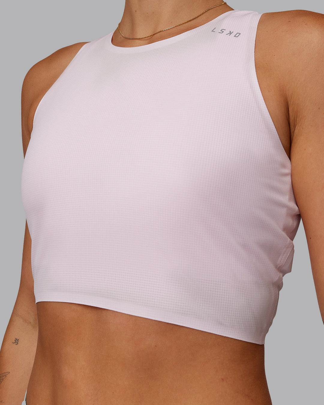 Woman wearing Race Day Cropped Performance Tank - Festival Bloom-White