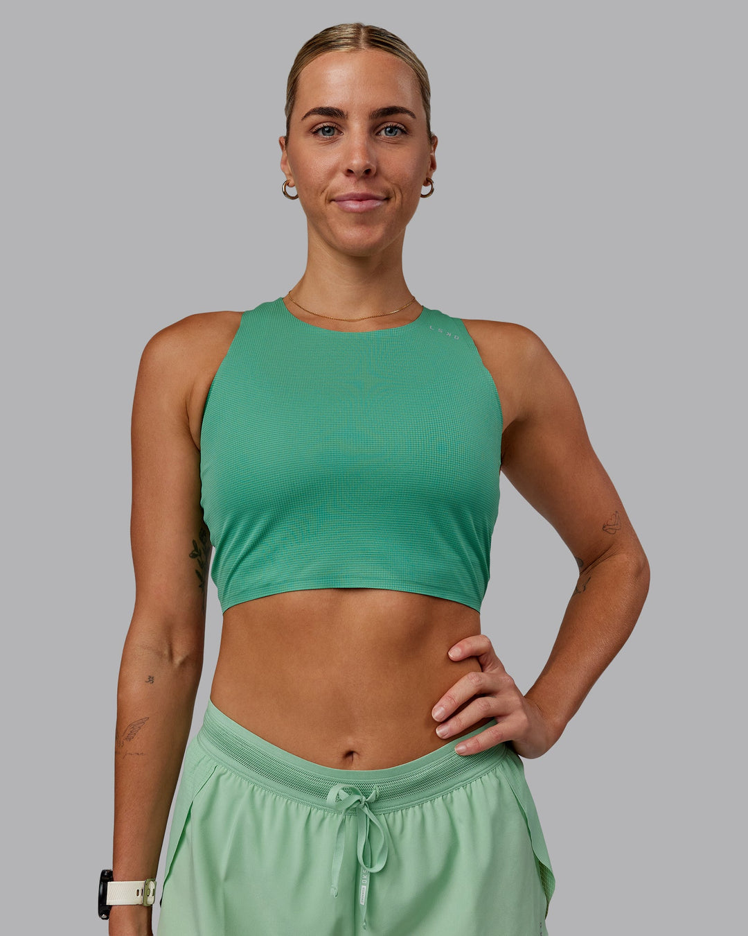 Woman wearing Race Day Cropped Performance Tank - Mystic Green-Surreal Green