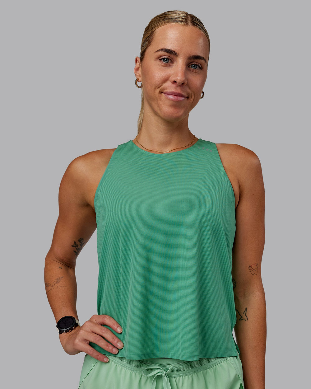 Woman wearing Race Day Performance Tank - Mystic Green-Surreal Green