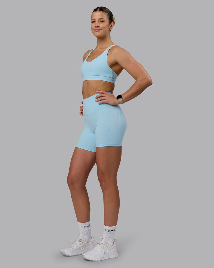 Woman wearing Radiance Sports Bra - Crystal Blue
