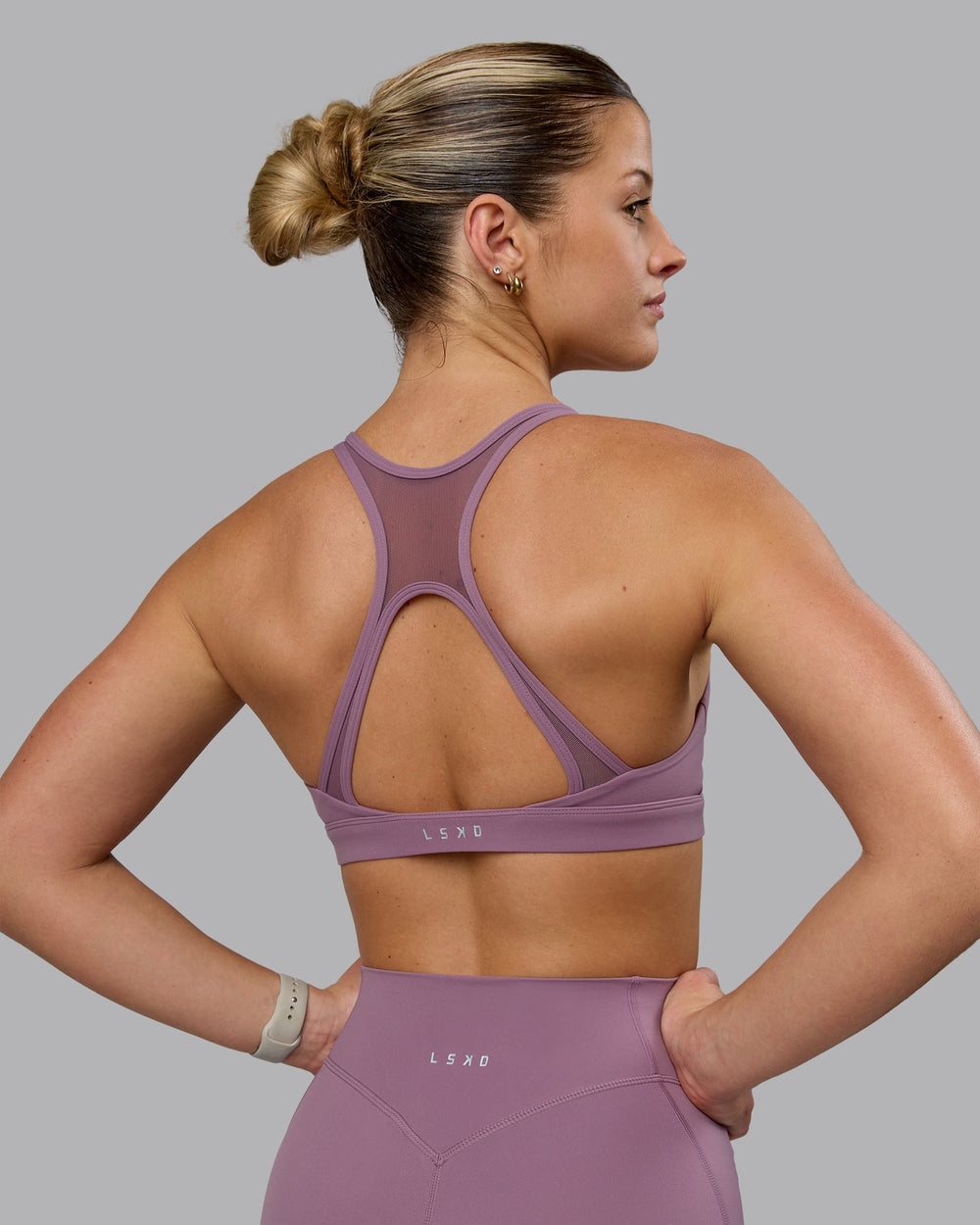 Woman wearing Radiance Sports Bra - Grape