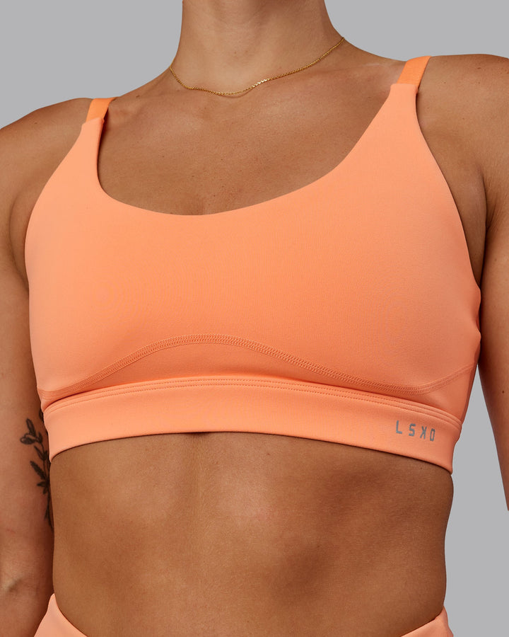 Woman wearing Rapid Sports Bra - Cantaloupe
