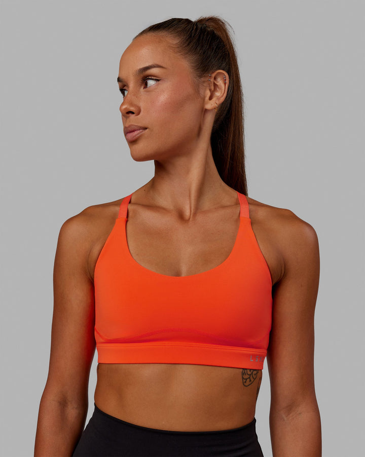 Woman wearing Rapid Sports Bra - Ultra Orange
