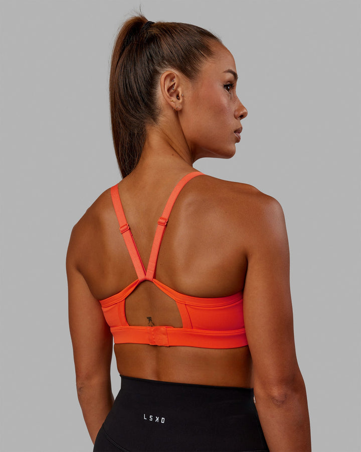 Woman wearing Rapid Sports Bra - Ultra Orange