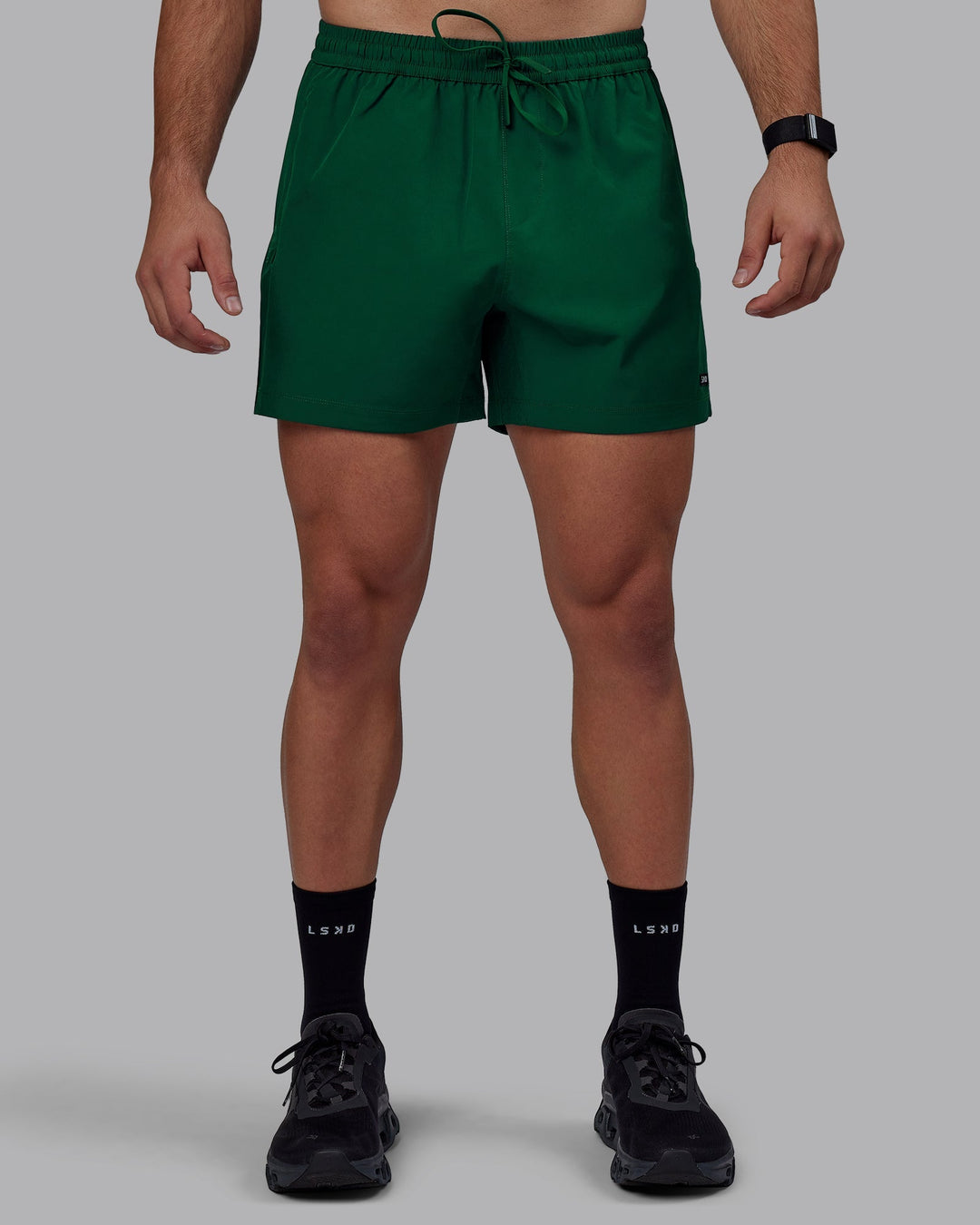 Man wearing Rep 5&quot; Performance Shorts - Deep Emerald