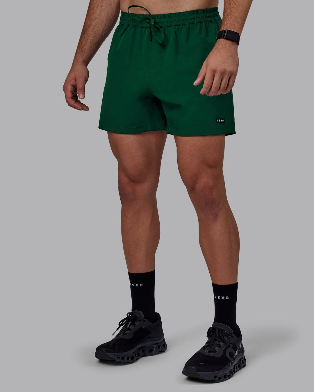 Man wearing Rep 5&quot; Performance Shorts - Deep Emerald