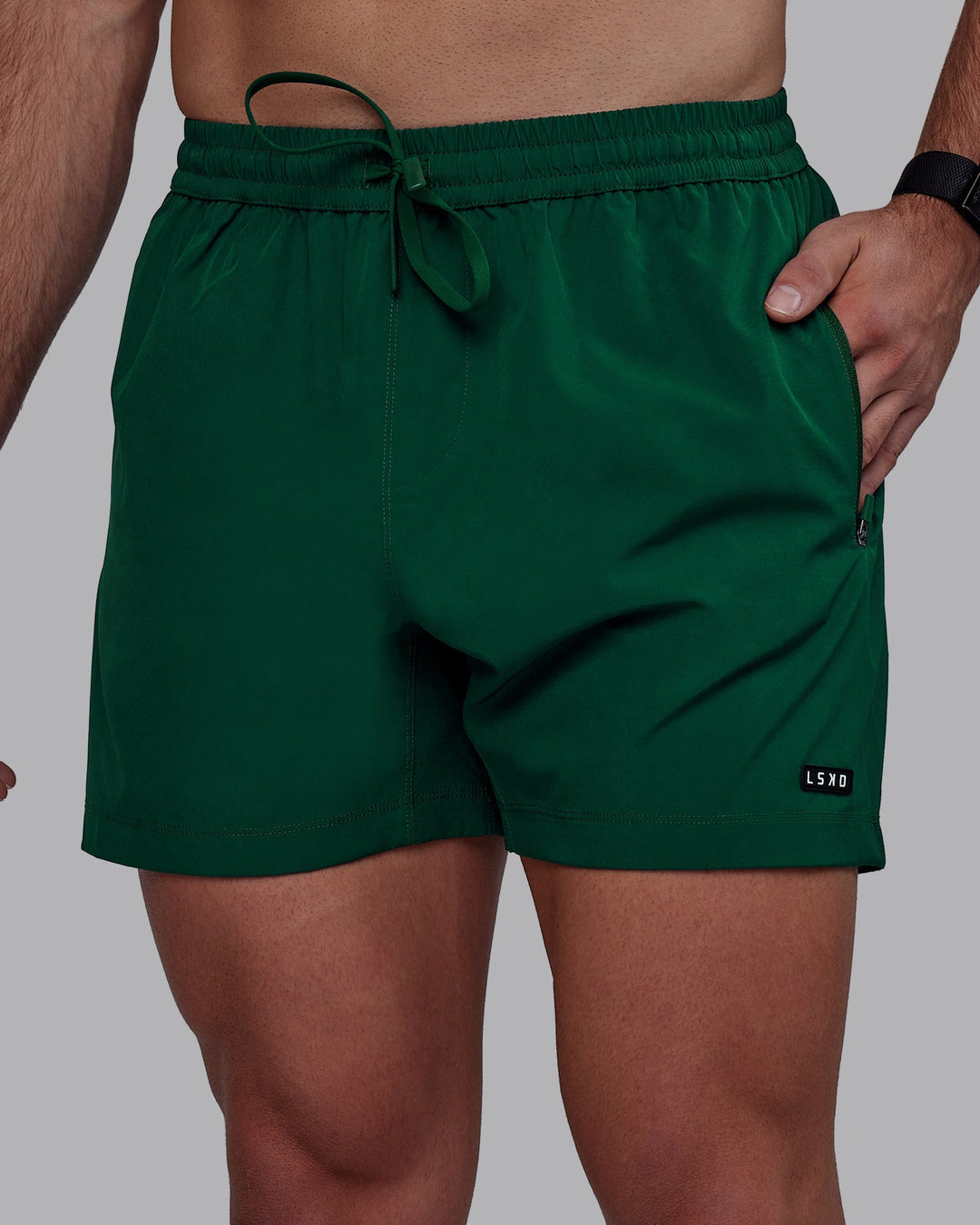 Man wearing Rep 5&quot; Performance Shorts - Deep Emerald