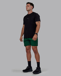 Man wearing Rep 7" Performance Shorts - Deep Emerald