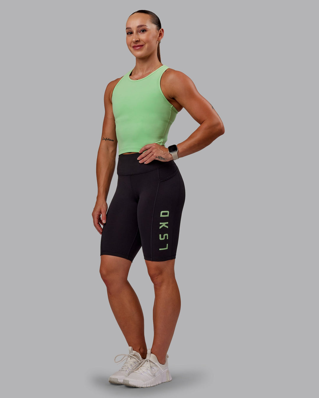 Woman wearing Rep Bike Shorts - Black-Surreal Green