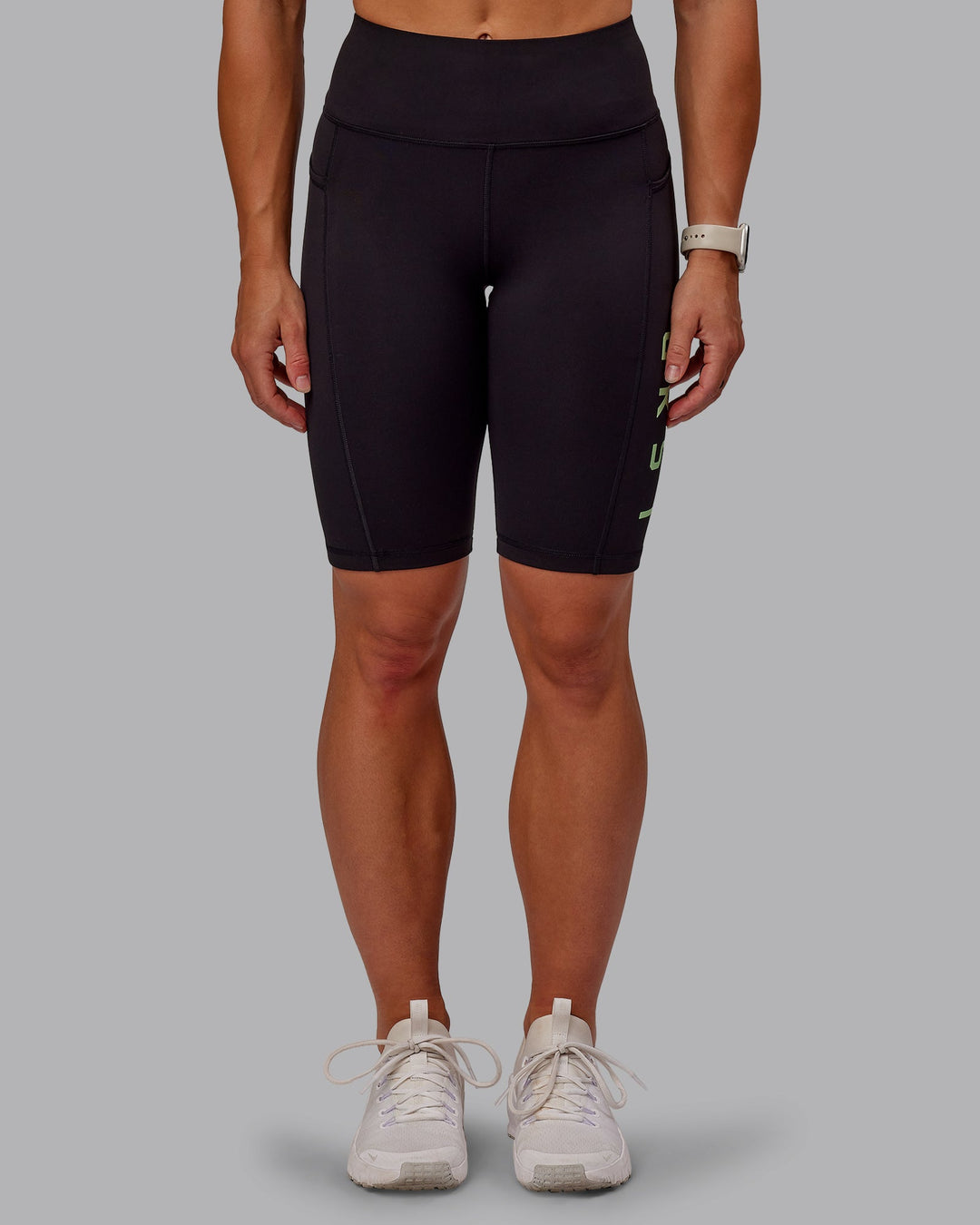 Woman wearing Rep Bike Shorts - Black-Surreal Green