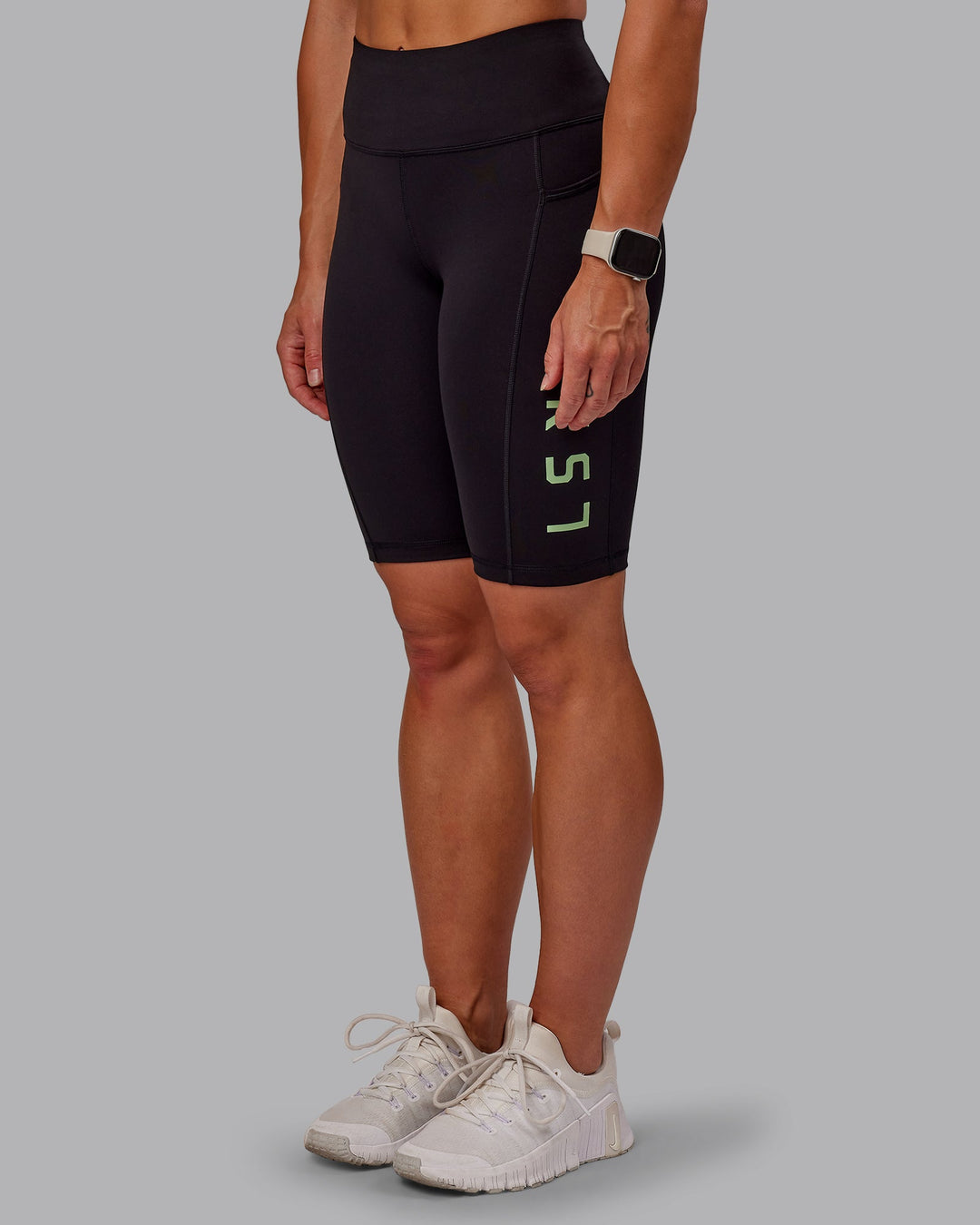 Woman wearing Rep Bike Shorts - Black-Surreal Green