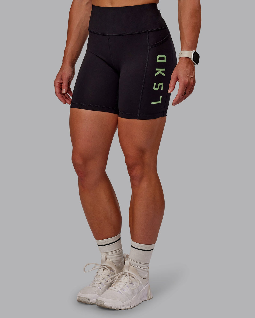 Woman wearing Rep Ultra High-Rise 6" Short Pockets - Black-Surreal Green