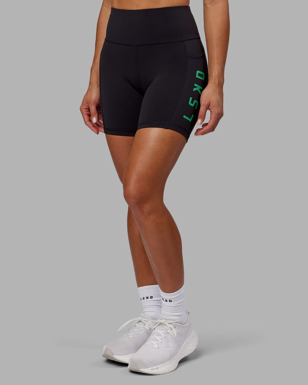 Woman wearing Rep Mid-Length Shorts - Black-Impact Green