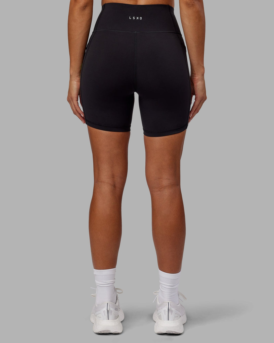 Woman wearing Rep Mid-Length Shorts - Black-Impact Green